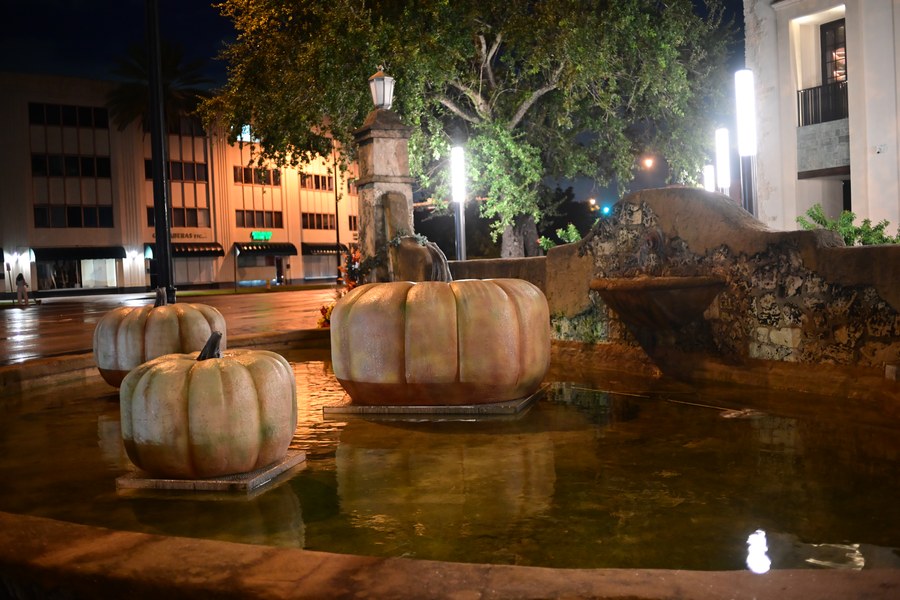 Autumn decorations reflected beside a fountain